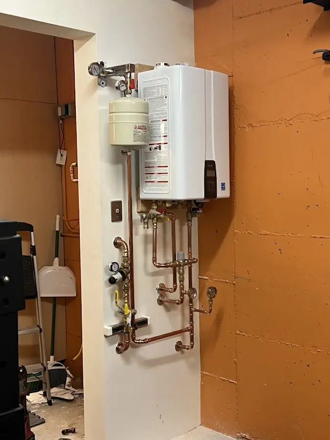 Plumbing technician inspecting water heater connections in Bellevue